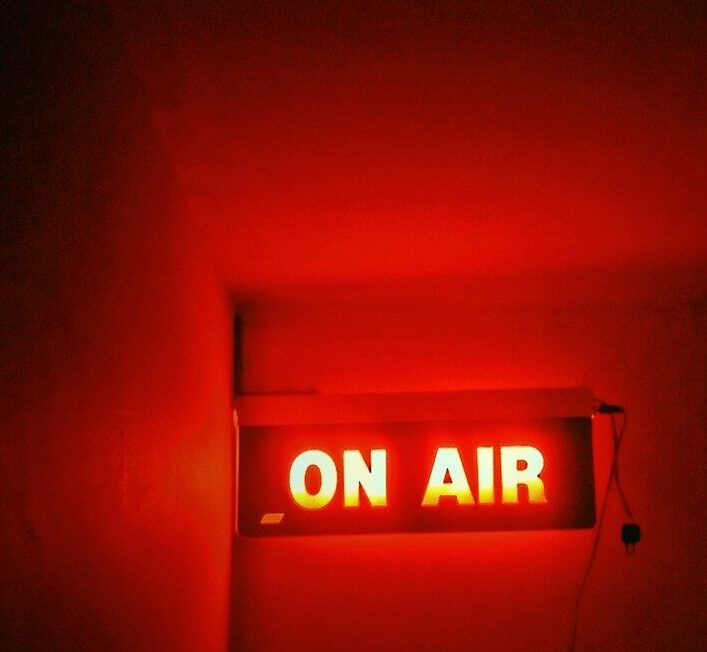 a red neon sign that reads on air